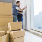 carton-boxes-near-blurred-couple